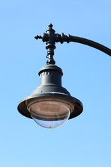 Wall Mural - A street light with a clear blue sky in the background, ideal for use in travel or urban-themed projects