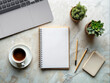© Victor Tcaci - Notepad Mockup with desk objects, plants, laptop, cup of coffee and pencils