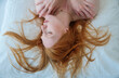 © ullision - portrait of attractive, young, sexy redhead woman, enjoys the fresh soft bed, relaxed in the morning sun