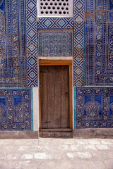 Sticker - A blue and white building with a wooden door