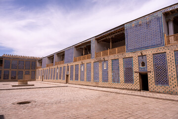 Sticker - A large building with blue and white tiles on the walls. The building is empty and has a lot of windows