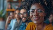 © 路加 石 - Happy multi-ethnic business people sit together in the office, laughing and smiling while listening to a close-up portrait of a lecture or training session
