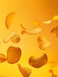 © Pascal - flying potato chips, isolated on yellow background