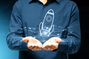 A person in a shirt displays a holographic rocket, digital double exposure on a blue background, startup concept