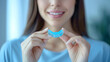 © GT MASTER - Woman holding a dental mouth guard for teeth grinding. Concept Dental care, Teeth grinding, Oral health, Preventive measures