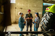 © Marko Geber - Diverse farmers discussing work in a barn
