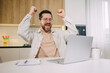 © Ivan - excited young man remote worker get email reward for performance of professional skills recognition promotion. Happy guy student sit by laptop celebrate good exam result