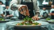 © ifoto - A chef with tattoos is plating up an elegant salad. The background shows other chefs in black aprons working on their dishes
