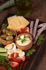 Wall Mural - antipasti board with cheese, olives and fresh vegetables
