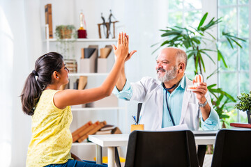 Wall Mural - Elderly, senior or old male Indian asian dentist with girl child patient in clinic