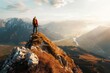 © DK_2020 - A hiker standing on a mountain peak with a panoramic view of the landscape below