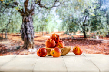 Sticker - Fresh ripe peaches on wooden table top in the park. Copy space for food, drinks and products.