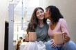 © Wavebreak Media - Woman sitting on stairs, kissing her partner's cheek while both hold mugs