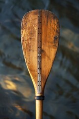 Wall Mural - Wooden paddle on a calm water surface for nature or travel designs