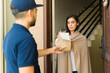 © AntonioDiaz - Courier delivering a package of medications to a woman wrapped in a blanket