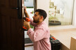 © AntonioDiaz - Skilled handyman installing a new lock in a front door of a house entrance using a screwdriver