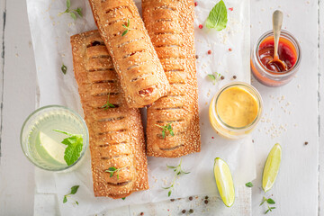 Wall Mural - Tasty and unhealthy hot dogs with puff pastry and sausage.