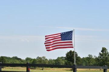 Wall Mural - American Flag on a Fence in a Farm Field