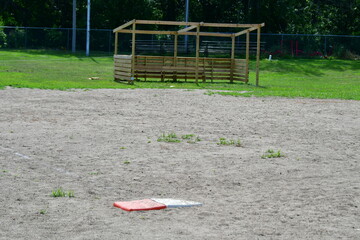 Wall Mural - Base on a Baseball Field with a New Wooden Dugout