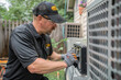 © KirKam - HVAC technician servicing an outdoor unit, showcasing professionalism in maintenance and repair work.