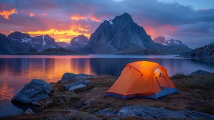 wild camping in the lofoten islands. camping tent among mountains. sunset over camping spot behind polar circle.