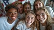 © sirisakboakaew - Advertising, friendship, patriotism and people concept - smiling teens in white t-shirts over an American flag