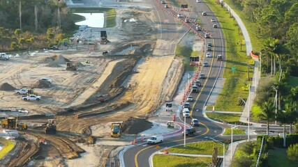 Canvas Print - American highway road under construction. Development of roundabout traffic infrastructure. State transportation concept