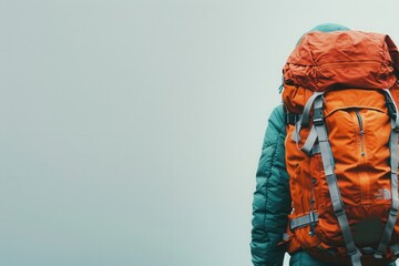 Aufkleber - A minimalist image showcasing a bright orange backpack on a simple, light blue backdrop. This simple yet impactful image symbolizes adventure, travel, and exploration