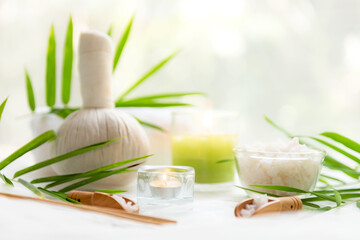 Wall Mural - Thai Spa Treatments aroma therapy salt and  sugar scrub massage with bamboo leaves with candle, white background. Thailand. Healthy Concept