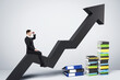 © Who is Danny - Man on an upward arrow looking forward, piles of books, grey background, concept of career growth