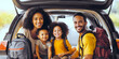 © Maxim Chuev - Happy family african american preparing their backpacking luggage in trunk of their car. young family prepare for a hike at back of their vehicle. family sitting inside car trunk to leave for vacation