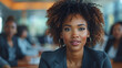 © Waris - Black business woman leading a group of colleagues in a modern office boardroom