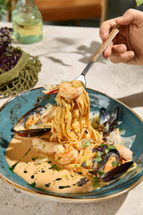 Wall Mural - Seafood Pasta in Creamy Sauce with Summer Light and Shadow Play