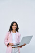 © Stock 4 You - Vertical portrait of young middle eastern Israel businesswoman using laptop pc online application for work isolated on white wall. Smiling happy indian, arabic woman in business suit holding computer