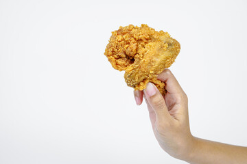 Female hand holding fried chicken on white background.