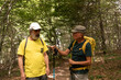 © Marino Bocelli - couple of smiling mature friends doing hiking in mountain woods dressed in sports clothes
