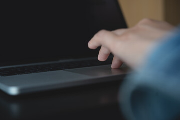 Wall Mural - close up of woman hands searching the information on laptop computer and surfing the internet on off
