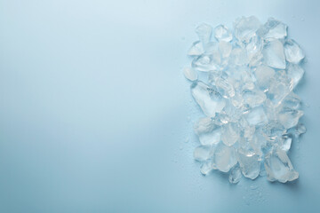 Poster - Pieces of crushed ice on light blue background, top view. Space for text