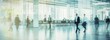 © Prompt2image - A blurred image of business people walking through a modern office lobby with large windows. The image is taken from a low angle, showcasing the bright, open space