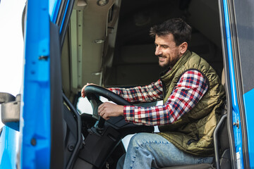 Wall Mural - Young  truck driver starts the truck to go on a long journey.