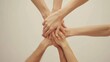 © Gia - This image shows five hands placed one on top of the other, symbolizing teamwork, unity, and collaboration, important concepts in group and community settings.