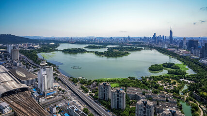 Wall Mural - Bustling Cityscape with Serene Lakeside