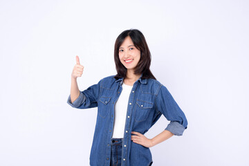 Wall Mural - Asian woman wearing denim jean is posing with thumbs up gesture on a white background.