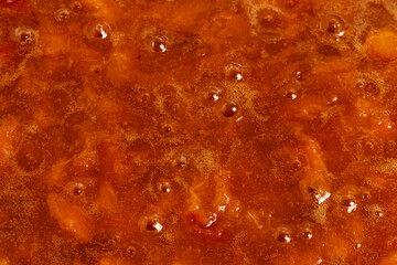 Freshly cooked, hot apricot jam. Close up.