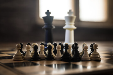 Wall Mural - Chess board game concept of business ideas and competition and strategy ideas concep. Chess figures on a dark background with smoke and fog. Selective focus