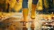 © Muzamil - feet in rubber boots rain puddle, fun in the rain, lifestyle
