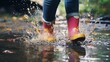 © Muzamil - feet in rubber boots rain puddle, fun in the rain, lifestyle
