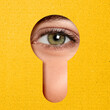 © New Africa - Woman looking through keyhole in yellow surface