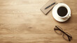 © aviavlad - Coffee, notebook, and glasses on wooden table