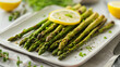 © Nii_Anna - Asparagus, grilled asparagus with lemon slices on a white plate, elegant dining setting, natural daylight, vibrant and appetizing mood, neatly arranged presentation, casual tableware